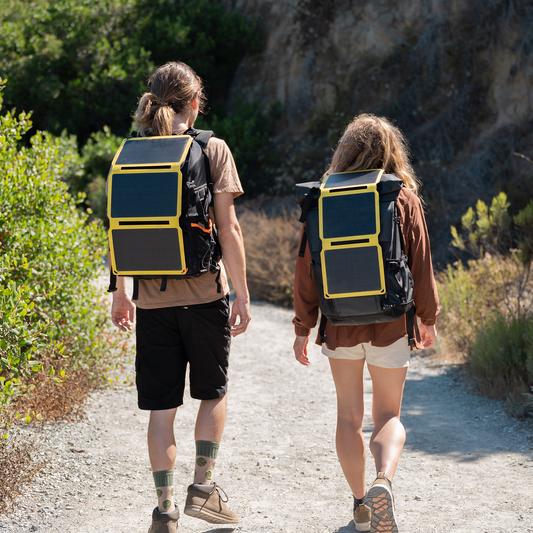 SunJack 15W foldable solar panel charging a phone outdoors